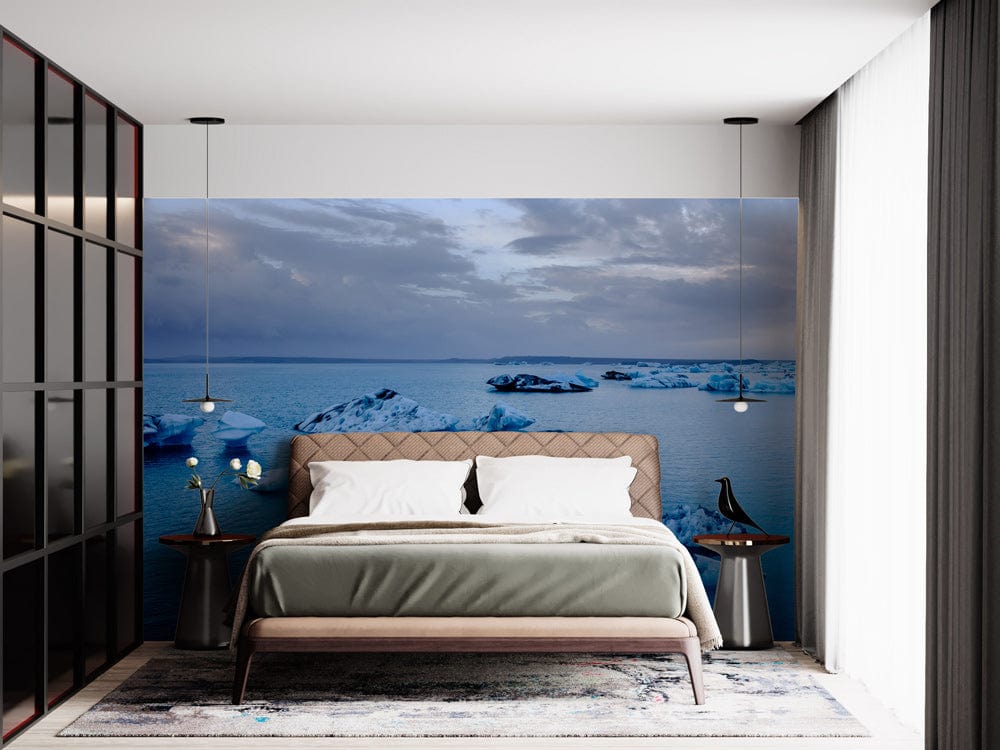 Modern bedroom with Arctic Iceberg mural wallpaper, elegant bed, minimalist decor, pendant lights, and carpet.