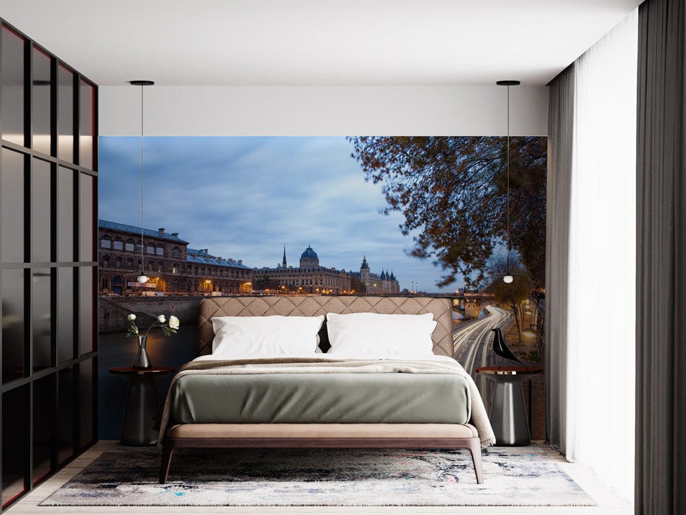 Elegant Paris River Scene Mural Wallpaper in bedroom with modern bed, neutral walls, and stylish rug.