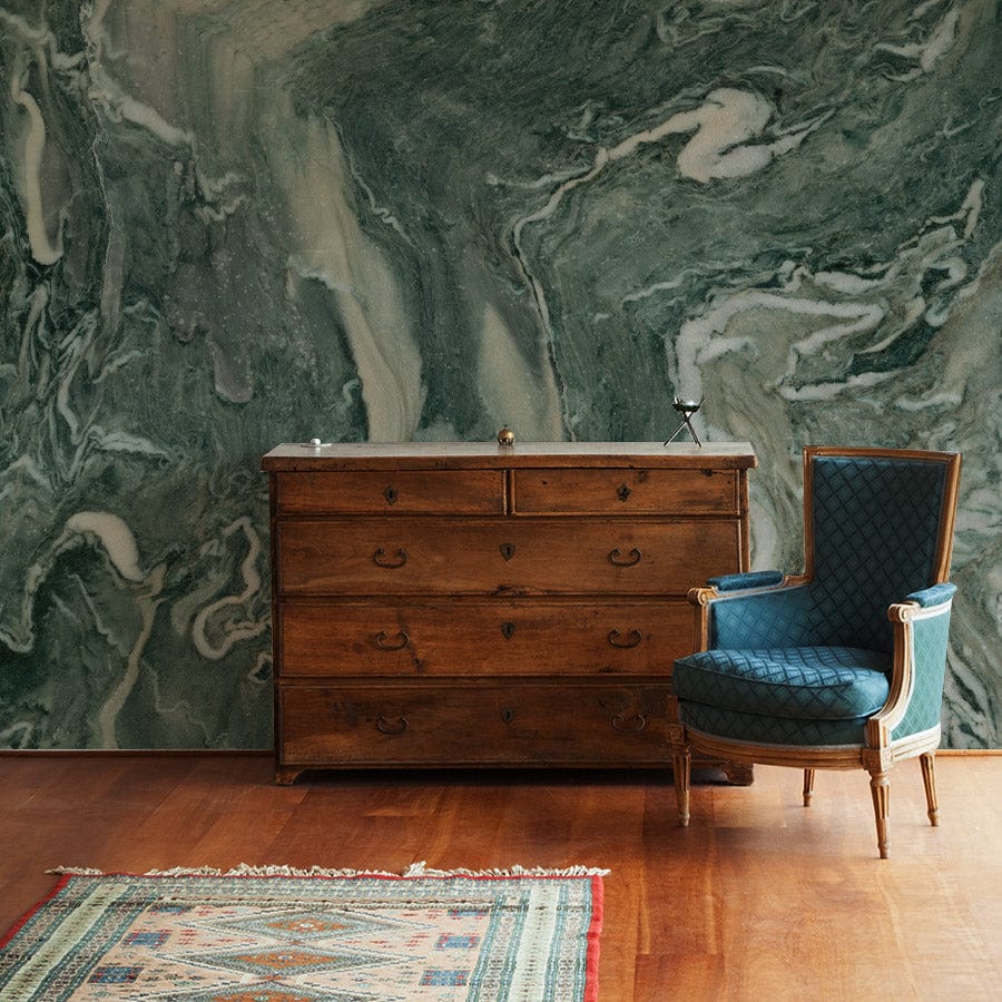 Green marble effect wallpaper in living room, featuring elegant patterns, with vintage chair and wood dresser.