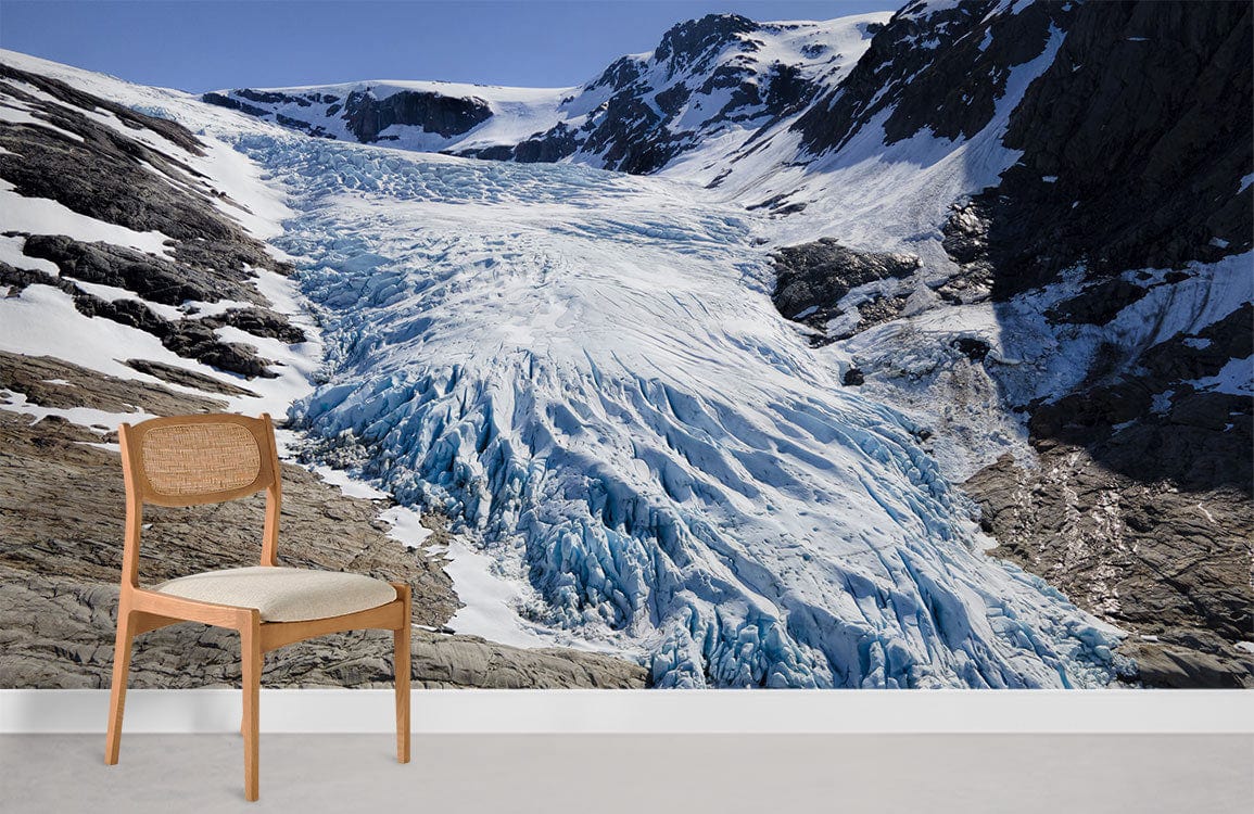 Majestic Glacier Landscape Mural Wallpaper, wooden chair, minimalistic room, cool blue and grey tones.