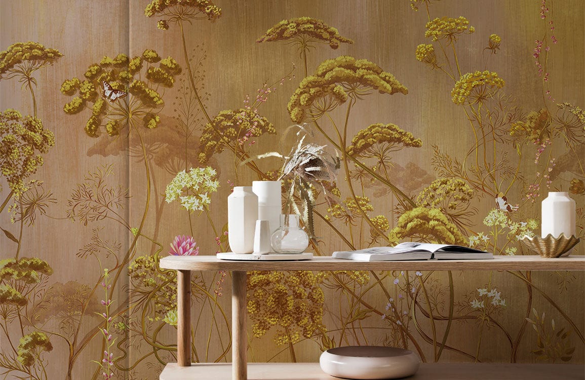 Golden Botanical Meadow Mural Wallpaper in vintage floral design with elegant light wood desk in room.