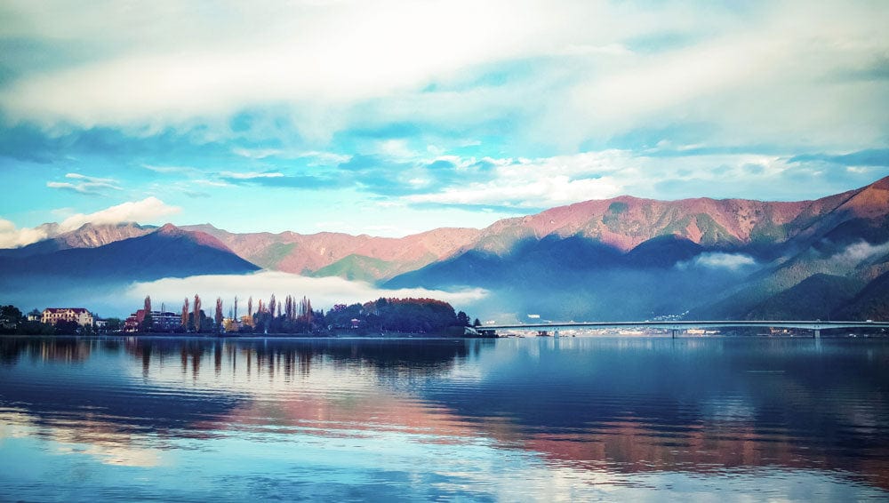Tranquil Mountain Lake Panorama Mural Wallpaper in Serene Blue Tones