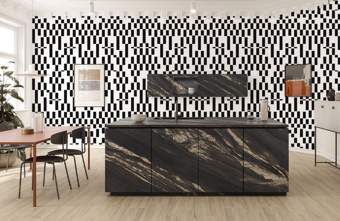 Monochrome geometric wallpaper in modern kitchen with dark island, wooden flooring, black chairs, and table.