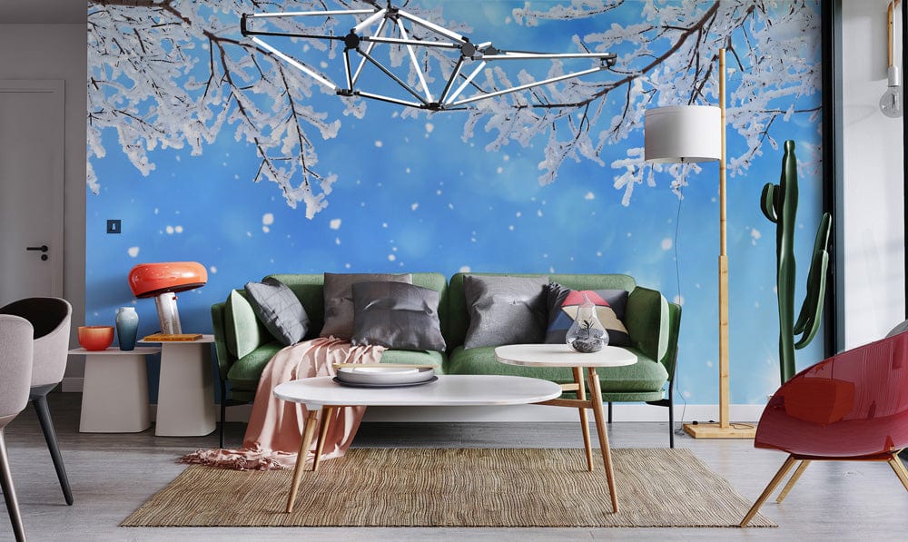 Winter Wonderland mural with snowy branches, green sofa, modern tables, and grey flooring in lounge.