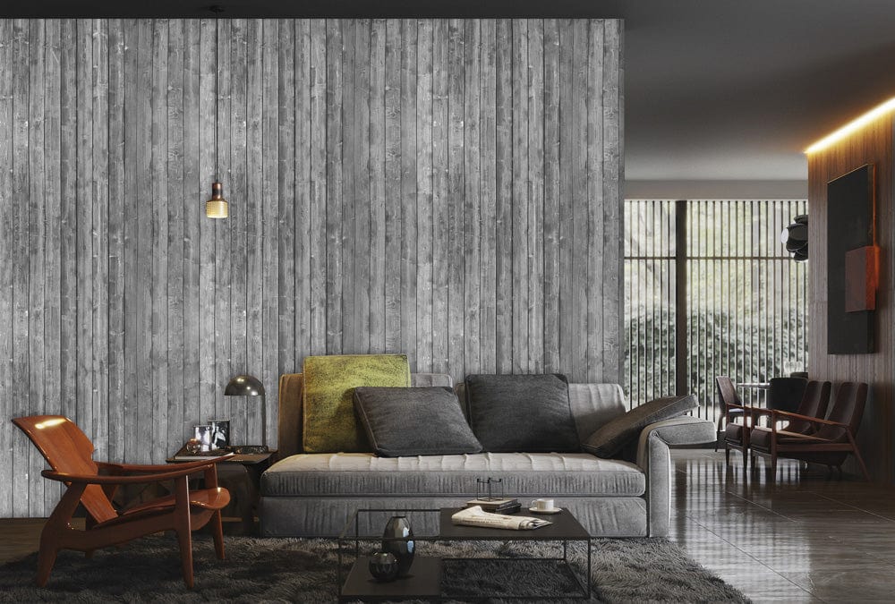 Rustic grey wood plank wallpaper in vintage industrial style with grey sofa, modern chairs, and lamp.