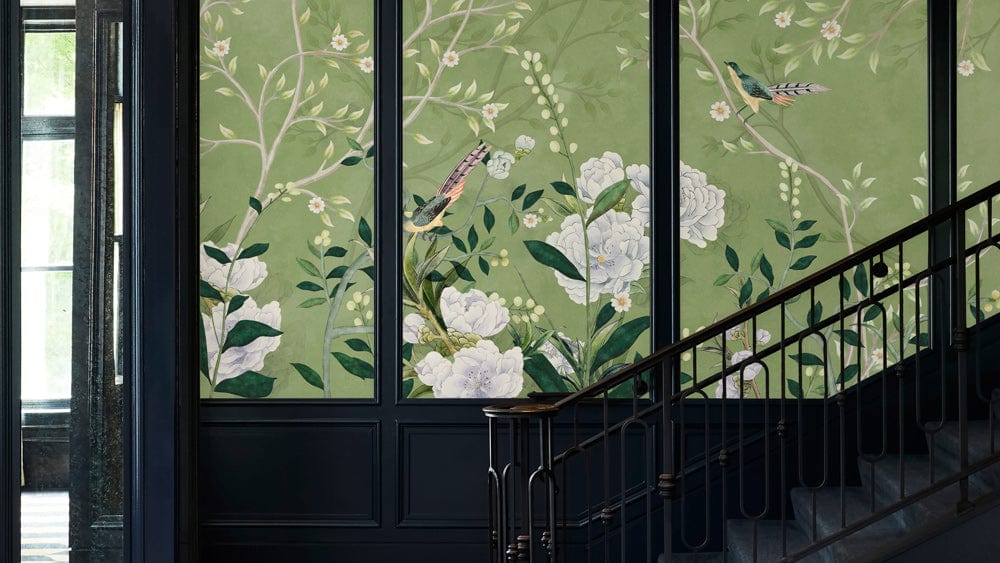 Elegant green floral mural wallpaper with birds, traditional style, stairway setting, dark-panelled walls.