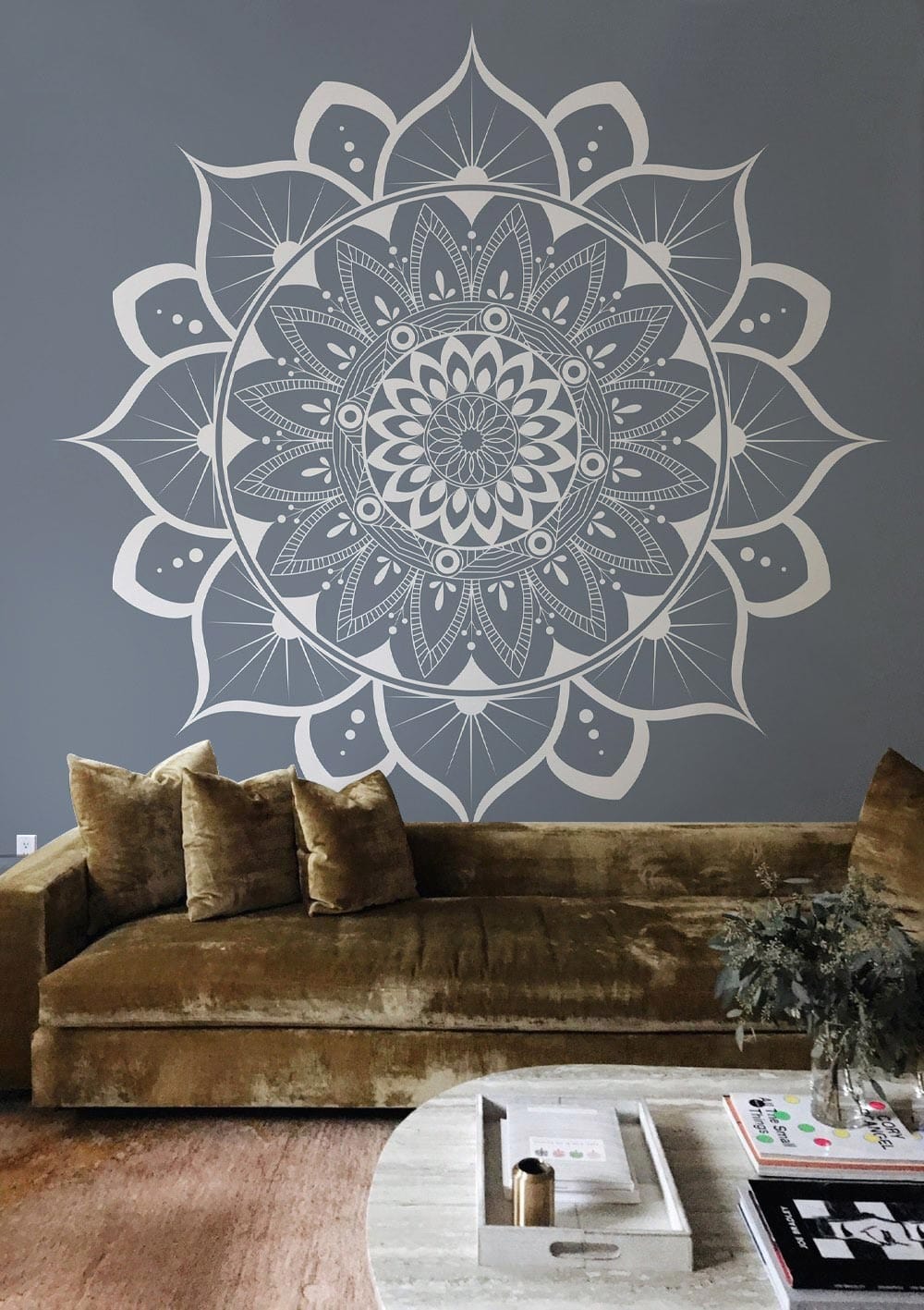 Elegant grey mandala wallpaper, velvet brown sofa, modern interior style, neutral textured flooring.