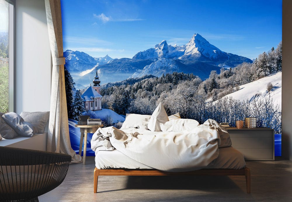 Majestic Alpine winter scene mural wallpaper in modern bedroom, grey floor, white bed, natural light.