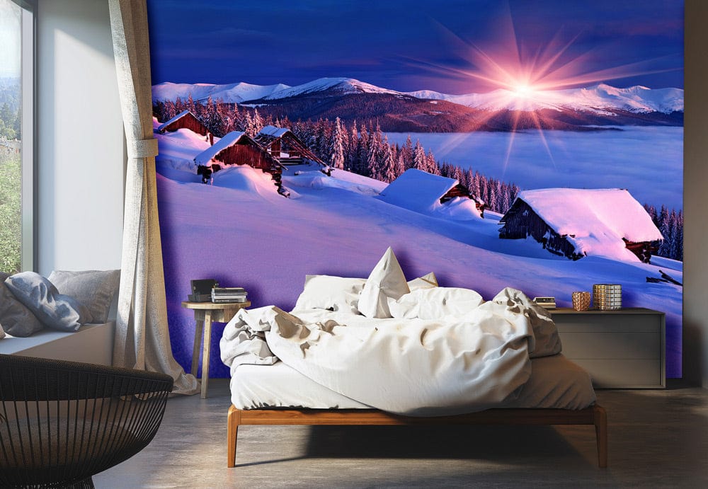 Sunset Alpine mural wallpaper in purple hues, bedroom setting, modern bed, grey flooring, cosy atmosphere.