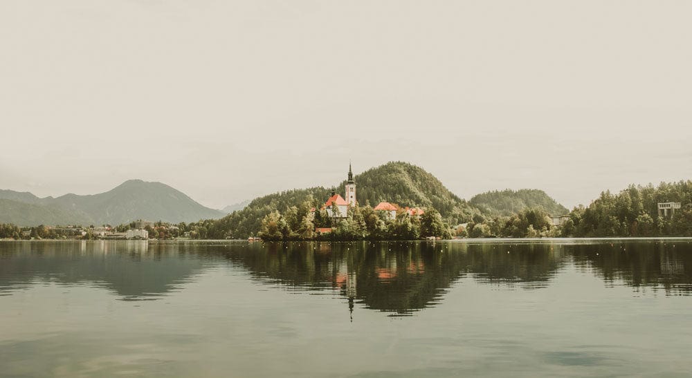 Tranquil Lakeside Village Mural Wallpaper - Serene Scenic Landscape Design