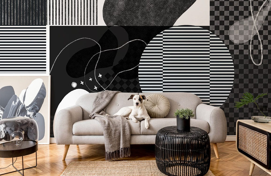 Monochrome abstract geometric wallpaper in modern lounge with light grey sofa, parquet flooring, black coffee table.