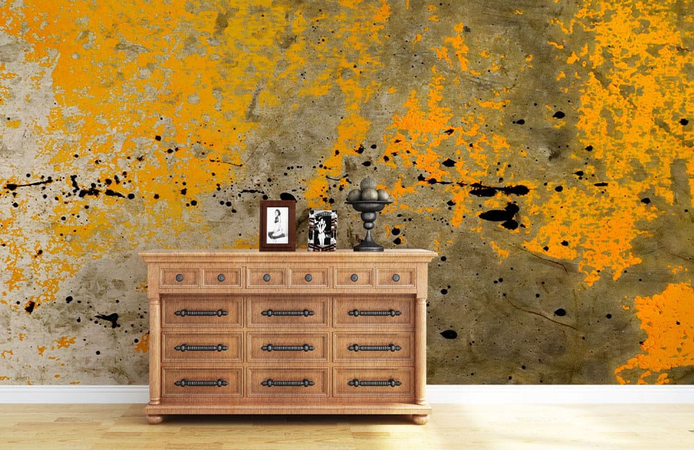 Industrial Urban Grunge Abstract Mural with wooden chest, yellow-grey wallpaper in contemporary living room.