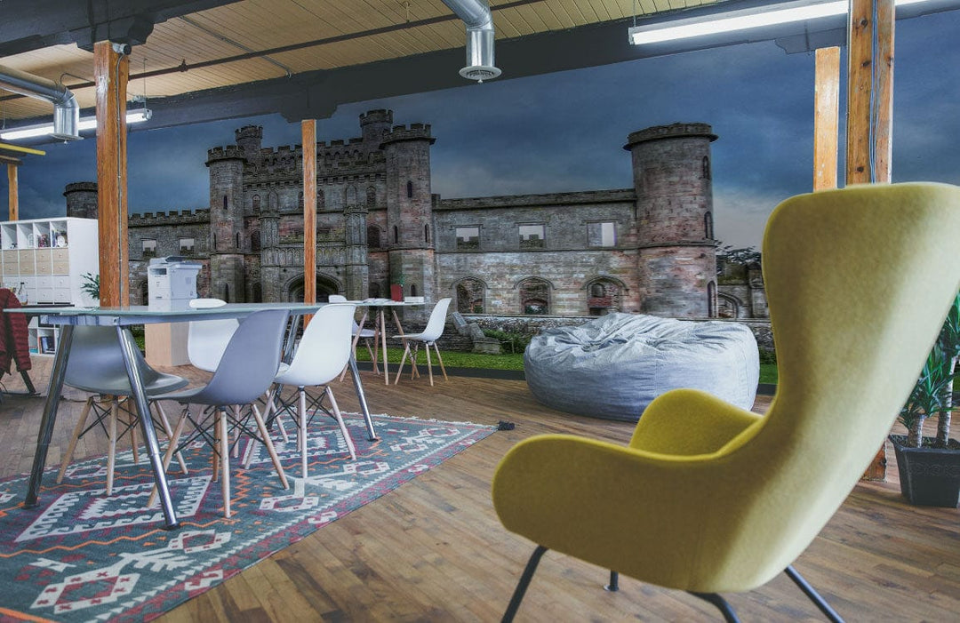 Majestic Stone Castle Mural Wallpaper with grey tones, office setting, wooden flooring, yellow modern chair.
