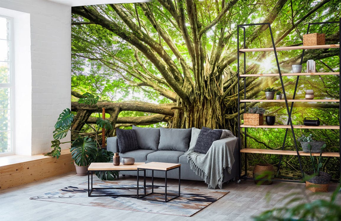 Majestic Green Forest Tree Mural Wallpaper in living room with grey sofa, light wood flooring, industrial shelves.