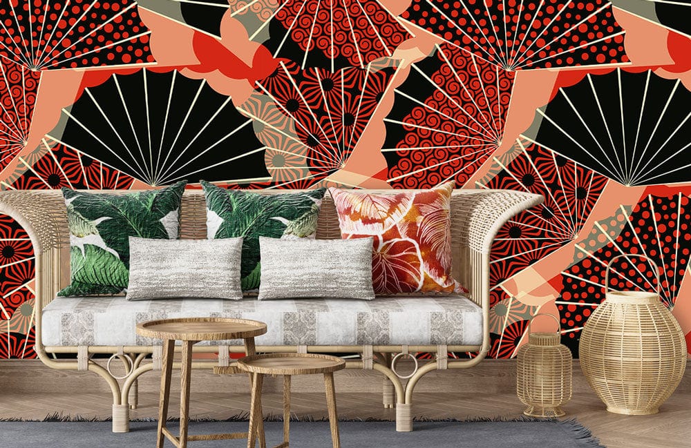 Elegant wallpaper with Oriental fan pattern; wicker furniture, grey rug, light wood flooring, vibrant cushions.