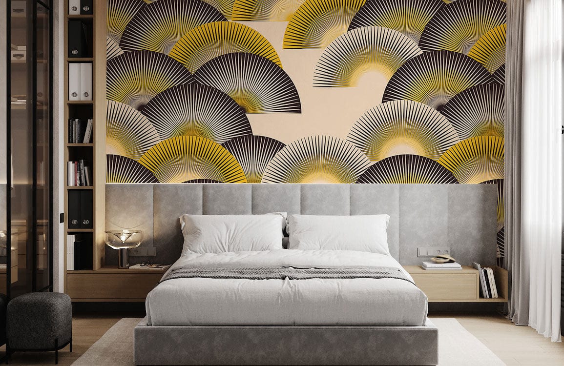 Art Deco fan pattern wallpaper in yellow, black, and cream, grey upholstered bed, modern bedroom setting.