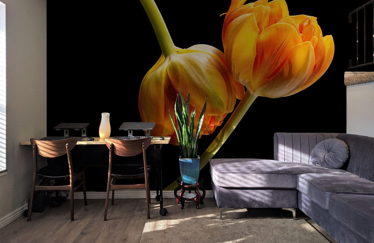 Vibrant Orange Tulip Mural Wallpaper decorates living room with grey sectional sofa and wooden flooring.