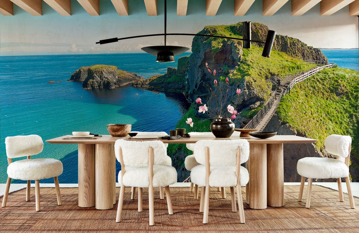Dining room with Tranquil Coastal Cliff Mural Wallpaper, wooden table, white chairs, and stylish lighting fixture.
