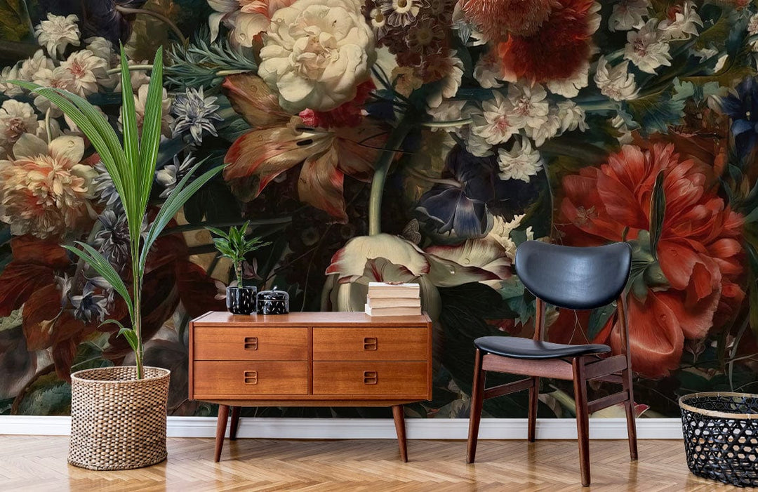 Vintage floral mural wallpaper with dark blooms; mid-century console, black chair, chevron wood floor.