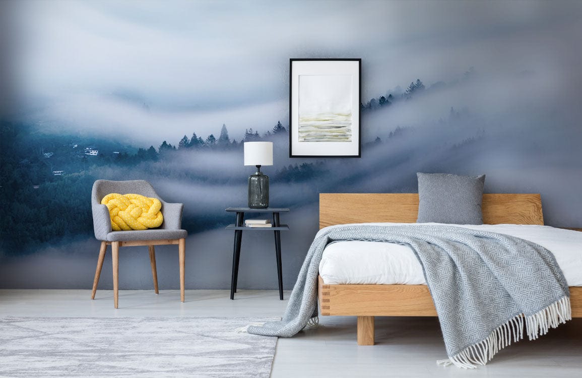 Tranquil Misty Forest mural in serene blue, modern bedroom with grey chair, wooden bed, light rug.