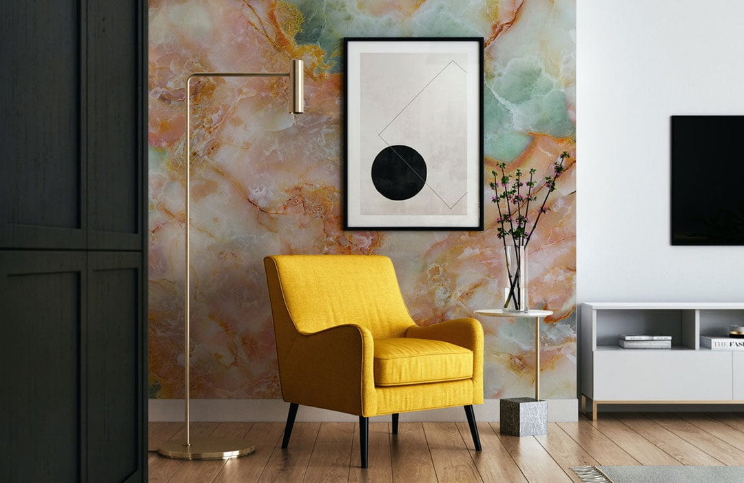 Colourful marble effect wallpaper, yellow armchair, wooden flooring, modern abstract art, living room.
