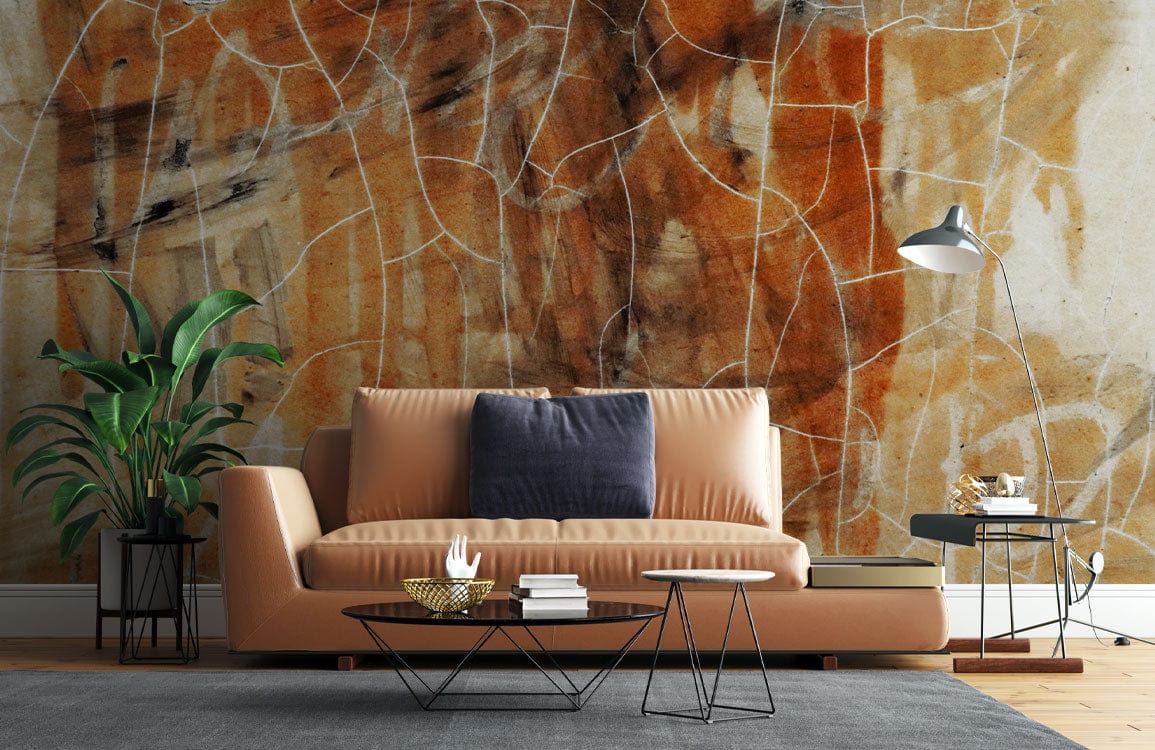Rustic abstract mural wallpaper with earth tones behind modern beige sofa in stylish living room.