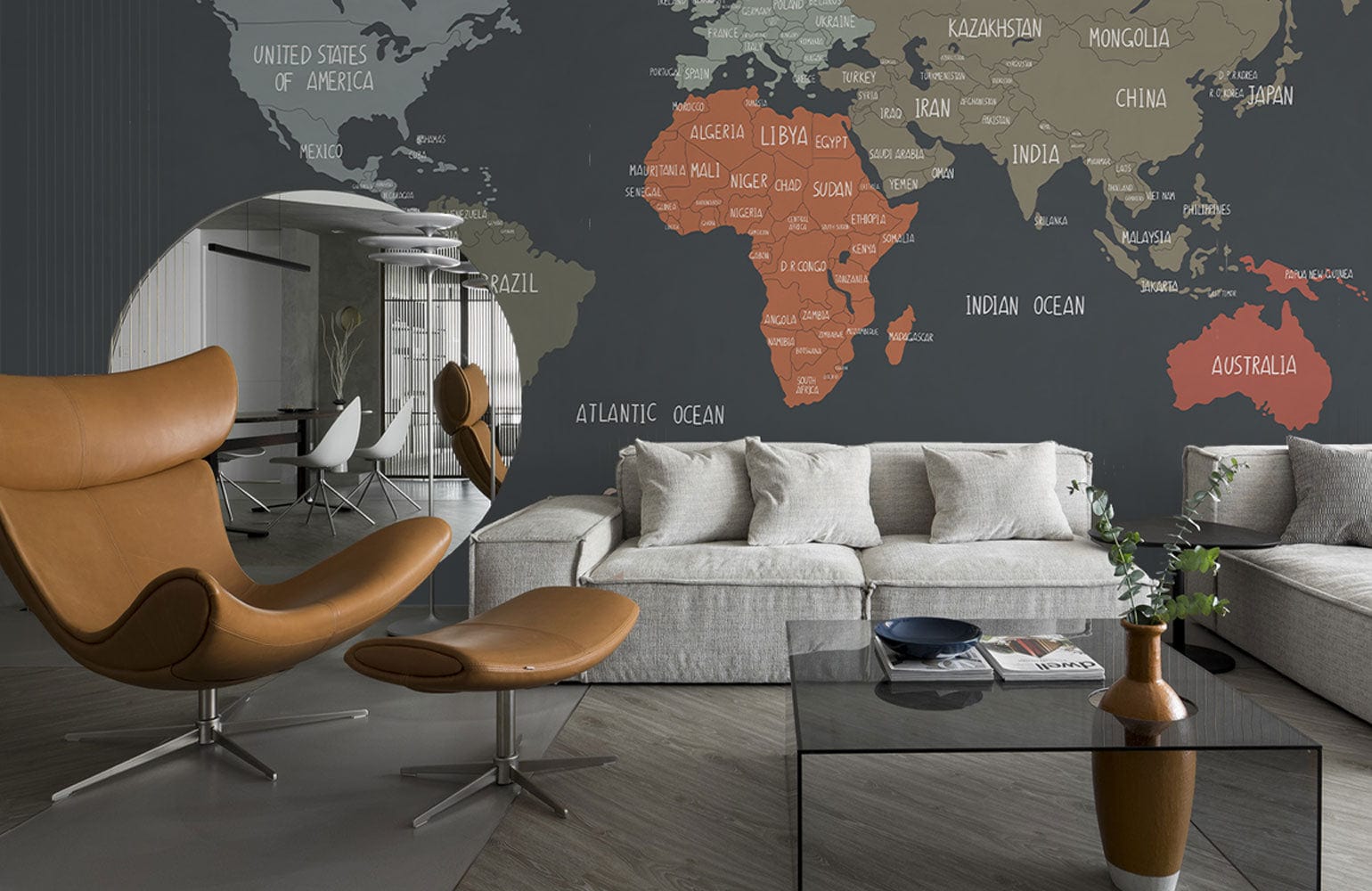 Vintage World Map Mural Wallpaper in Earthy Tones, modern living room, beige sofa, brown chair.