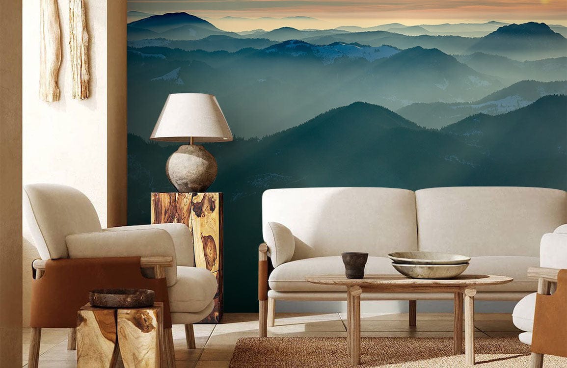 Elegant living room with Serene Mountain Ridge mural wallpaper, cream sofa, wooden table, and stone lamp.