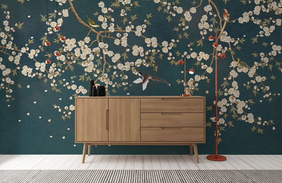 Elegant teal blossom branches wallpaper with birds, mid-century sideboard, wooden flooring, oriental style.