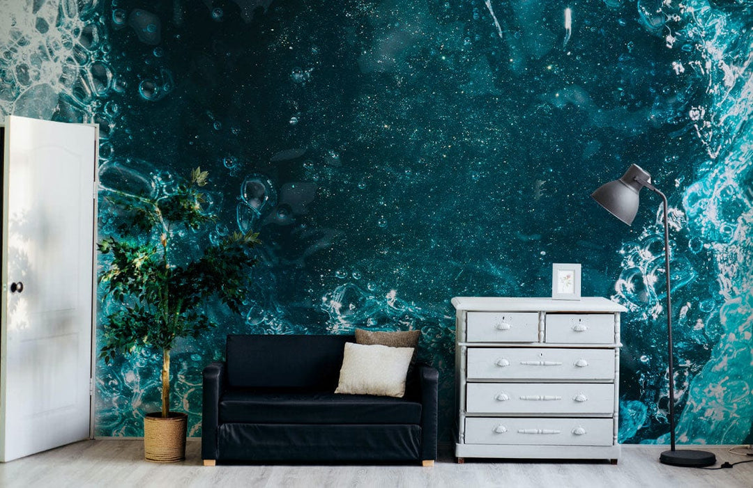 Oceanic teal abstract bubbles mural in living room with black sofa, white dresser, floor lamp.