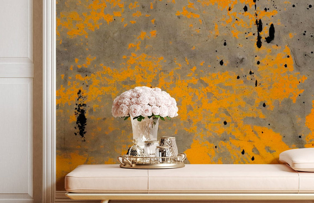 Industrial yellow and grey mural wallpaper; modern interior with cream bench, floral decor, elegant style.