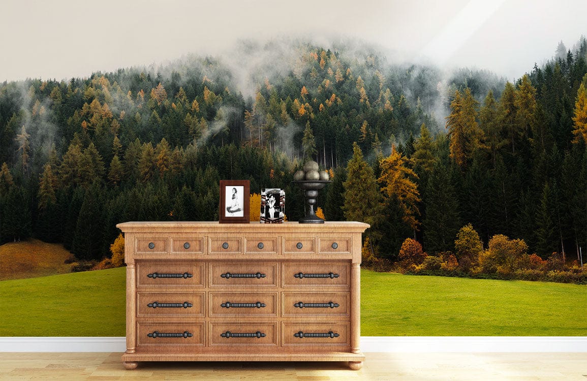 Chestnut wood dresser, Misty Autumn Forest mural wallpaper, lush green, golden hues, light wood flooring.