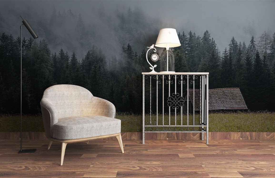 Rustic forest mural wallpaper with grey armchair, metal side table, and wooden flooring in living room.