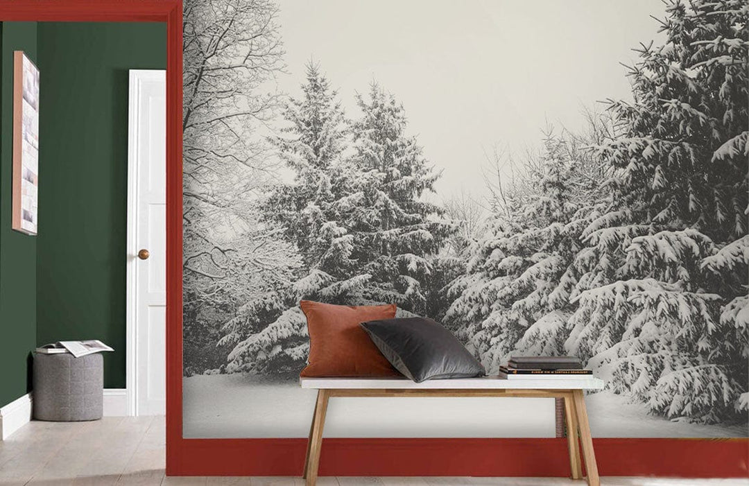 Winter Wonderland Black and White Forest Mural Wallpaper in green-panelled room with bench and cushions.