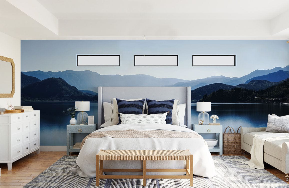 Bedroom with Peaceful Blue Lake Mural, grey bed, white dresser, wooden flooring, and serene decor.