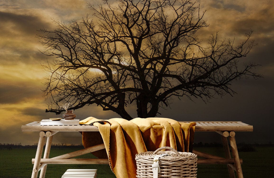 Solitary Tree Sunset mural wallpaper, serene landscape; warm tones, rustic bench, wicker basket, cosy decor.