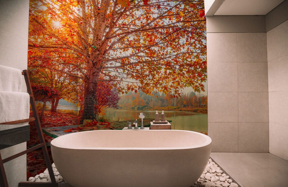 Vibrant Autumn Lake View Mural Wallpaper in a modern bathroom with freestanding bathtub and pebble flooring.