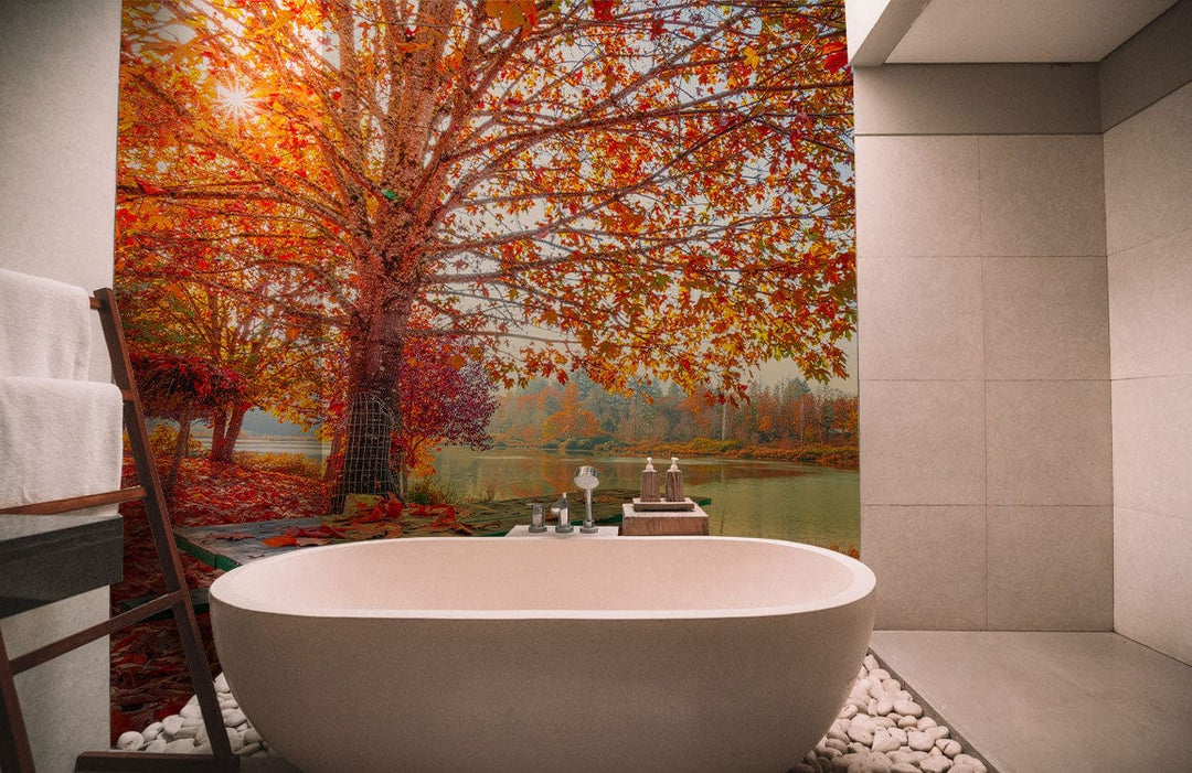 Vibrant Autumn Lake View Mural Wallpaper in a modern bathroom with freestanding bathtub and pebble flooring.