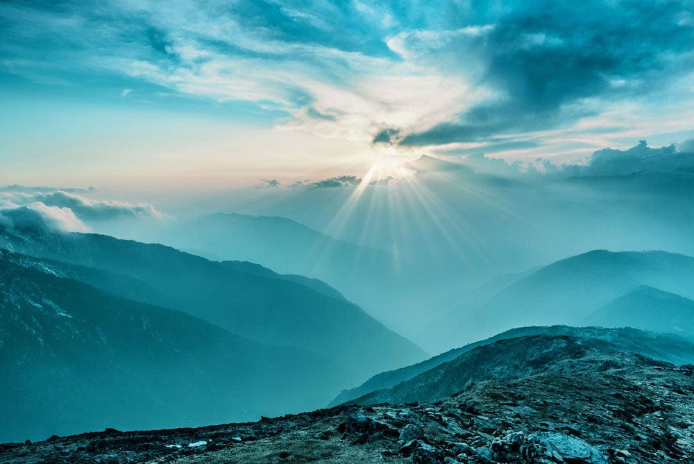Serene Mountain Sunrise Mural Wallpaper in Tranquil Blue Tones