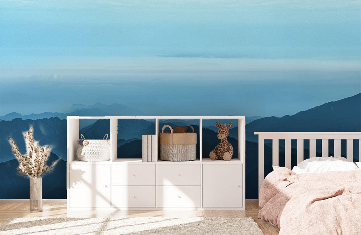 Tranquil Blue Mountain Landscape Mural Wallpaper with white furniture, pink bedding, wooden flooring.