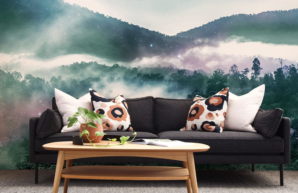 Mystical forest mist mural wallpaper with dark sofa, patterned cushions, wooden table in living room.