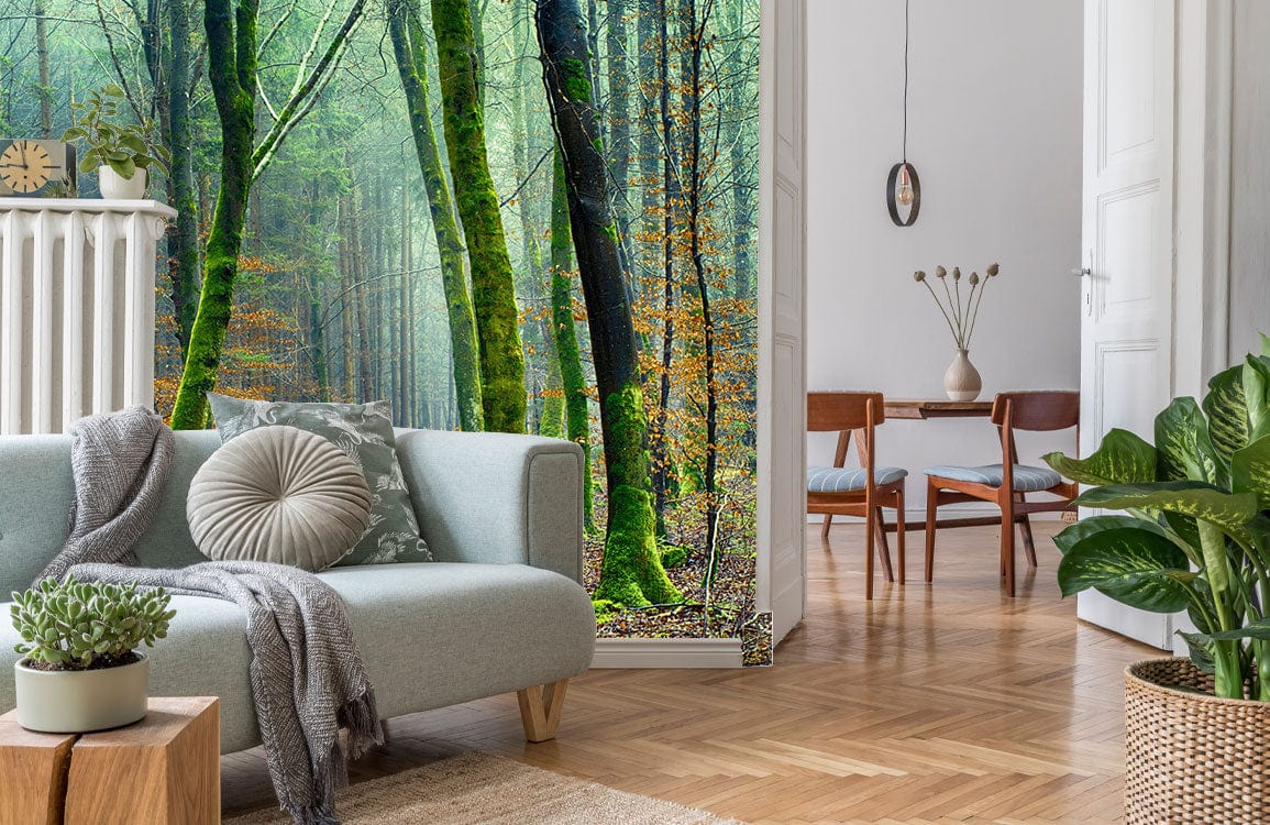 Mystical Green Forest mural wallpaper in living room with light grey sofa and wooden flooring.