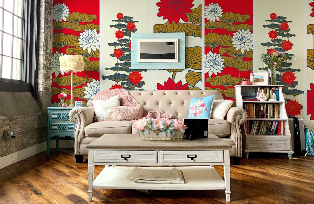 Red Gold Floral Bloom Wallpaper Mural in living room with beige sofa, rustic wood flooring, light decor.