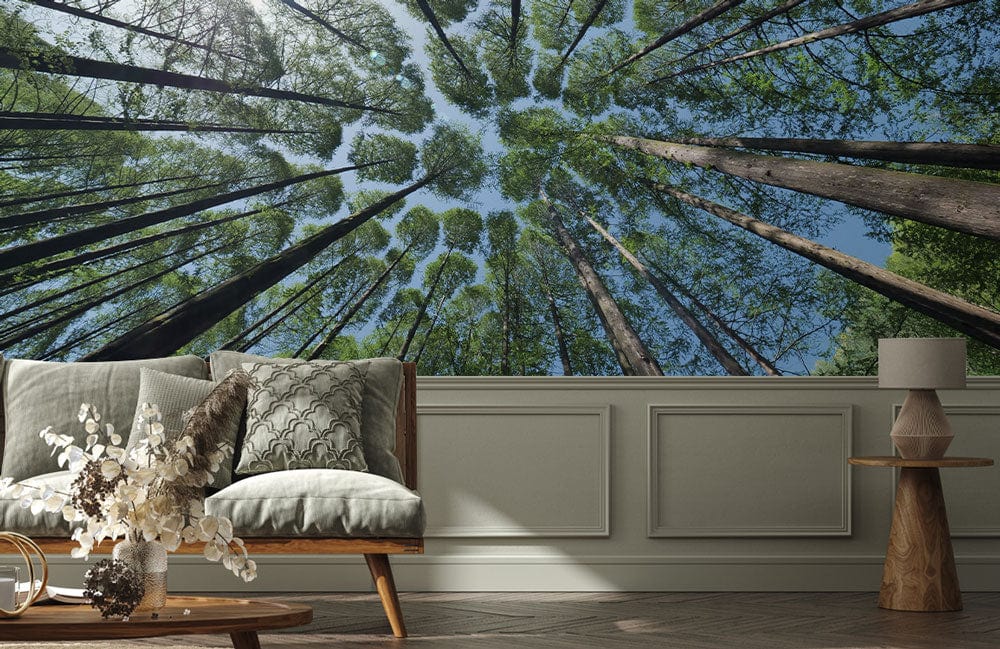 Forest-themed mural wallpaper, wooden sofa, green cushions, modern lamp, panelled wall, parquet flooring, living room.