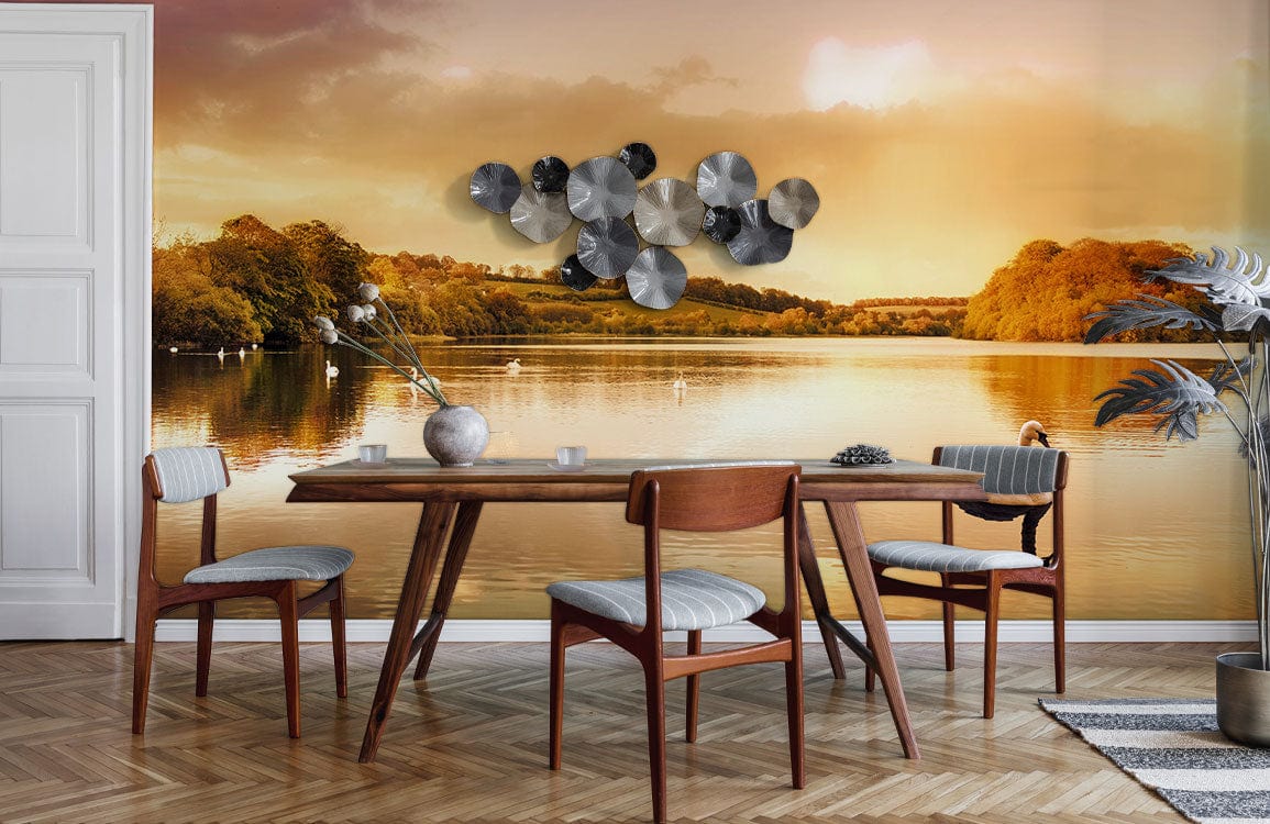 Golden Sunset Lake Scene Mural Wallpaper enhances dining room with serene swan reflections and wooden furniture.