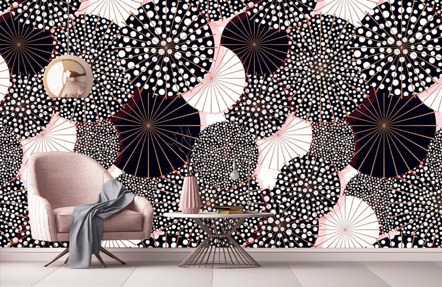 Abstract umbrella patterned wallpaper, pink chair, round mirror, neutral flooring, modern living room design.
