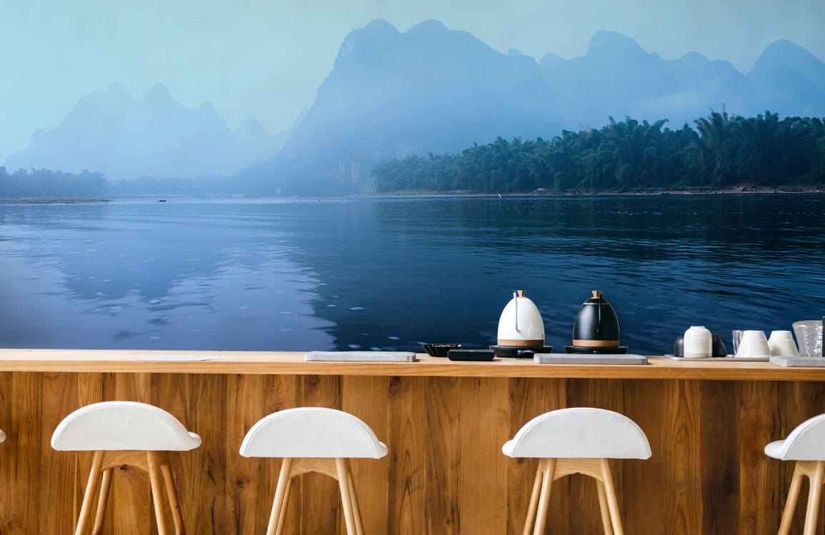 Tranquil Misty Blue Mountain Wallpaper with Wooden Bar Stools, Modern Kitchen Decor, Serene Atmosphere.