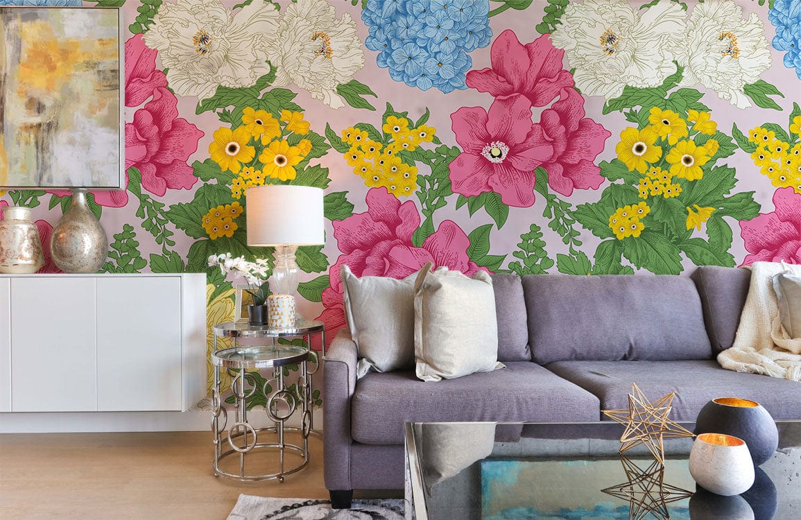 Bright botanical wallpaper with pink flowers, grey sofa, white cabinet, glass table in modern living room.