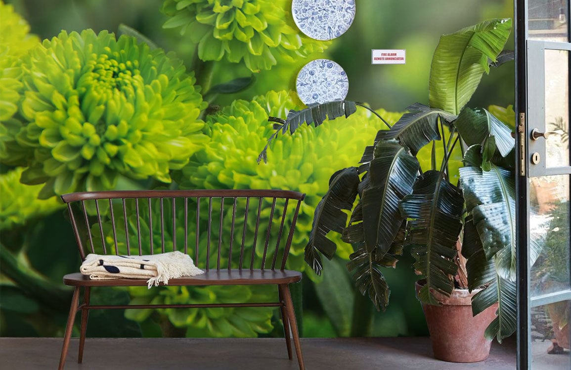 Mural wallpaper with vibrant green flowers, wooden bench, modern decor, and lush indoor plant.