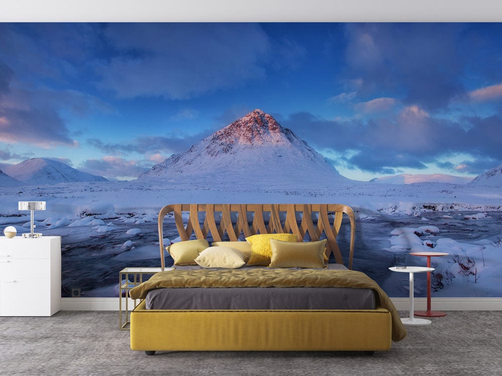 Serene Winter Mountain Mural in bedroom with mustard bed, grey carpet, and minimalist white furniture.